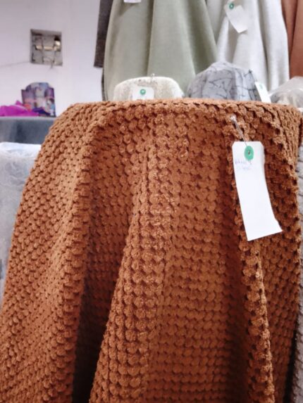 Bubble fabric Close-up of bubble fabric upholstery on armchair, showcasing soft and durable texture for home furniture